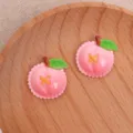 Gros plan de détails d'accessoires DIY en résine de pêche rose, tranche de fruit pour cheveux. - Pêche