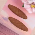 Detalle de pinza de pelo ovalada de tela marrón accesorio hecho a mano DIY primer plano - Café