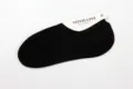 Detail view of women solid black low cut invisible boat socks, thin summer cotton anti slip. - One Size / Black