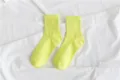 Close-up detail of fluorescent yellow crew socks, showing smooth cotton texture and knit cuff. - Size 35-40 / Neon Yellow