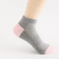 Grey and pink ankle sock detail, breathable mesh design, comfortable athletic sock view. - One Size / Dark Gray