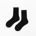 Close-up detail of classic black cotton crew socks with ribbed cuffs for women everyday wear. - One Size / Black