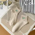 Detail view of beige ribbed cotton socks with green embroidery, soft texture and breathable fit. - EU 40-44 / Beige (OHH Embroidery)