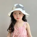 Close-up detail of the cute white bucket hat with a stylish houndstooth bow for sweet kids. - Cream White Houndstooth Bows