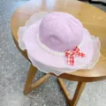 Cute pink baby bucket hat with white pearl lace ruffle and red plaid bow for summer. - 54cm / Violet
