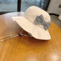 Cute beige kids bucket hat with black and white houndstooth bow and adjustable chin strap sun hat - Beige Houndstooth Bows