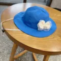 Cute baby girl blue bucket hat detail shot, featuring a white mesh bow and adjustable strap. - 48-54CM / Sapphire Blue