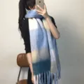 Detail view of the cozy colorblock plaid thick warm winter scarf with soft fringe. - Indigo Blue - With Label