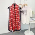Classic red and navy plaid scarf with fringe, stylish warm winter accessory for women. - Red