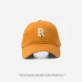 Orange cotton baseball cap with stylish white R embroidery, perfect for casual sun protection. - Adjustable (55-59cm) / R Badge / Brown