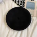 Classic black wool beret hat for women, cozy winter painter hat accessory stylishly displayed. - M (56-58cm) / Black