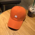 Orange baseball cap for women and men, stylish curved brim sun hat with white M embroidery. - Adjustable / Orange Red
