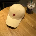 Beige baseball cap for women and men, stylish cotton curved brim sun hat with red M letter. - Adjustable / Beige
