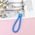 Detailed close-up of the vibrant blue braided leather keychain with sturdy metal ring. - Wrapped Leather Cord / Medium Blue