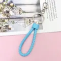 Blue braided leather keychain with metal ring and clasp, stylish accessory for car keys. - Wrapped Leather Cord / Light Blue
