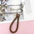 Brown braided leather keychain detail, metal keyring and clasp, premium everyday carry accessory. - Wrapped Leather Cord / Brown