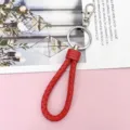 Red braided leather keychain with metal ring and clasp, perfect for car keys and bags. - Wrapped Leather Cord / Red