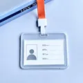 Transparante horizontale identiteitskaartouder met oranje lanyard voor medewerkersbadge. - Oranje