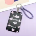 Black purple card holder with heart print and purple braided wrist strap, ideal for daily use. - Black with Small Hearts / Purple Edged Hand Rope