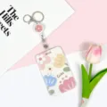 Cute floral retractable badge reel with sliding card holder, perfect for students and staff. - Cute Four Flowers / White Retractable Badge Reel (Pink Flower)