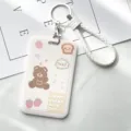 Minimalist white card holder with cute cartoon bear print, braided strap and keychain for daily use. - 100% Strawberry Bear & White Edged Leather Cords