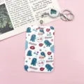 Cute dinosaur print card holder with retractable reel and keychain, ideal for student ID badges. - Many Little Monsters with White Retractable Badge Reel (Monster)