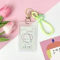 Transparent cartoon student card holder with cute dinosaur design, silicone strap and metal keychain. - Vertical PP Card Sleeve / Green Base Dinosaur + Green Rubber Keychain