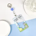 Transparent PVC card holder with cute cow design, retractable badge reel and keychain strap. - Cow on Meadow + White Retractable Buckle (Blue Smiley) / Sliding Transparent / Blue Smiley Accessory
