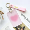 Transparent student card holder with pink silicone strap and gold keyring for daily use. - Pink Heart (With Pink Flower Keychain)