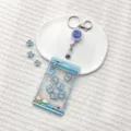Blue claw machine ID card holder variant, cute shaking toy design with reel clip for students. - Blue Claw Machine Elephant Shaking / Transparent Sliding Cover + White Retractable Buckle (Blue Smiley Face)
