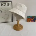 Closeup detail of white cotton bucket hat featuring stylish frayed heart embroidery patterns. - M (56-58cm) / White