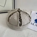 Close-up detail of the retro washed distressed docker cap featuring unique leopard print panels. - M (56-58cm) / Off White