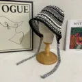 Handmade crocheted hollow knit bucket hat with long straps, detailed view of texture. - M (56-58cm) / Black