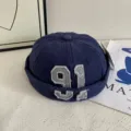 Detailed view of dark blue vintage docker hat featuring embroidered number detail. - M (56-58cm) / Navy Blue