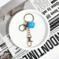 Metal keychain with blue bell pendant, lobster clasp and key ring for DIY crafts. - Gold Clasp Four-Section Chain (Light Blue Bell)