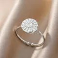 Stunning silver-tone open ring featuring a textured disc centerpiece on satin fabric closeup. - Round Relief Style (JZ4902P)
