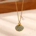 Gold plated shell pendant necklace with pearl detail, close up view of ocean jewelry design. - Shell Baroque Pearl Style (N08510G)