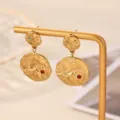 Close-up detail view of 18k gold plated textured drop earrings featuring red and blue crystal stones. - Geometric Texture Colored Gemstone Style (E7284)