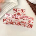 Transparent hair claw clip featuring a cute red bow and heart pattern, medium size for styling. - Bowknot Heart Transparent