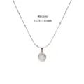 Detailed close-up of stainless steel oval white stone pendant necklace with bead chain. - White Gold Pink Cat's Eye Stone Style