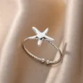 Close-up detail of a silver-toned starfish open ring with a twisted band texture. - Starfish Style (JZ4906P)