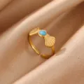 Closeup detail of a trendy 18k gold plated stainless steel ring with a blue stone accent. - Shell Bow Blue Enamel (JZ9822G)