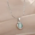 Exquisite oval mint green cat eye pendant necklace detail close-up, elegant subtle shine. - Light Green Cat's Eye Stone (N04669P-2) / Silver