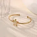 Gold-colored open cuff bracelet featuring a cute white inlaid turtle pendant, elegant style. - White Faux Jade Turtle Style (B2307G-3)