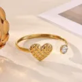 Detail shot of 18K gold plated stainless steel cuff bracelet with quilted heart and crystal. - Quilted Heart Style (B2271G)