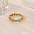 Close-up of gold-plated stainless steel evil eye ring, showcasing detailed bead and blue enamel. - Blue Evil Eye Style (JZ9957G)