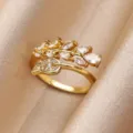 Elegant gold-plated open ring featuring a delicate leaf and branch design with sparkling cubic zirconia stones. - Gold Streamlined Branch Style (JZ9319G)