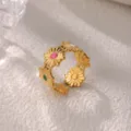 Detail view of gold stainless steel daisy ring with colorful enamel flower centers. - Daisy Pattern (JZ9392G)