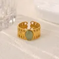 Stainless steel 18K gold-plated open ring featuring a green stone and geometric band. - Green Stone Hollow Geometric Style (JZ9843G)