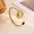 Stainless steel 18K gold plated open cuff bracelet with unique shell texture and black stone. - Black Rhinestone Triangle Shell Texture Style (B2272G-2)
